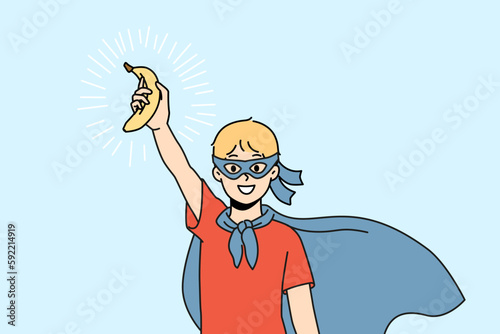 Smiling boy child in superhero costume hold fresh banana in hand. Happy kid eating super food enjoy fruits for healthy life. Vector illustration. 