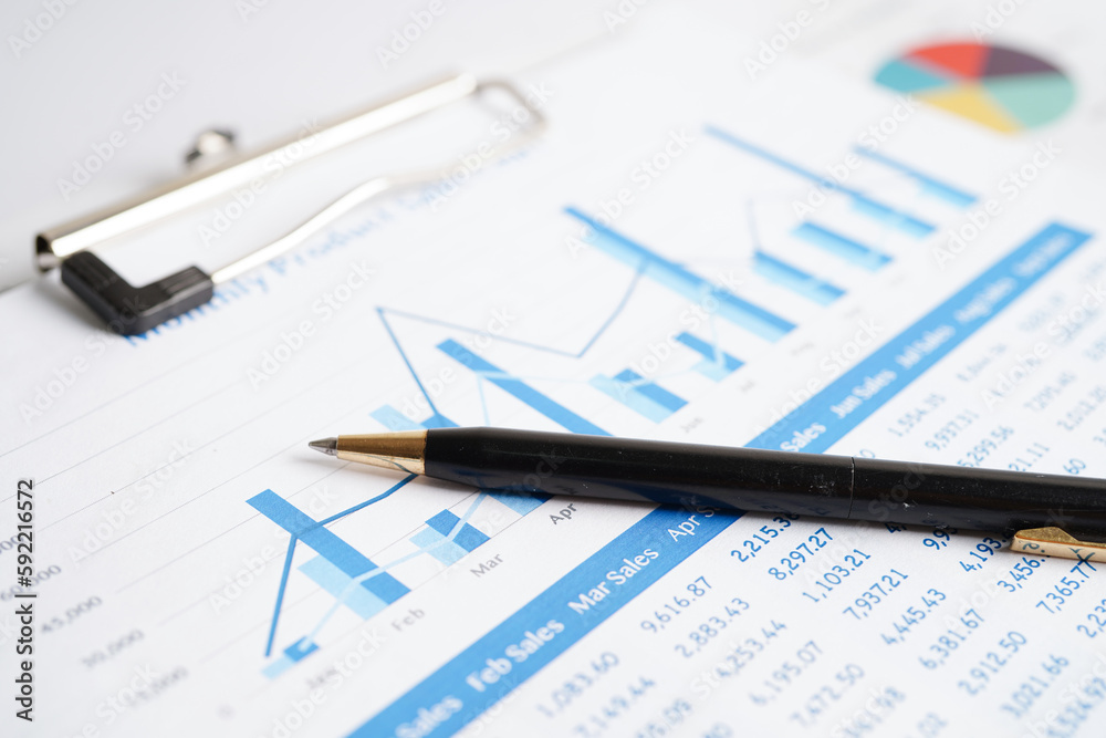 Pen on chart or graph paper. Financial, account, statistics and business data concept. Pen on chart or graph paper. Financial, account, statistics and business data concept.
