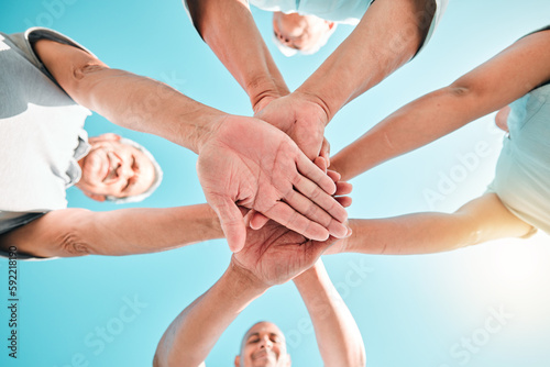 Group, hands stacked and teamwork by people in unity, support and collaboration together for a goal. Motivation, trust and team planning a goal, mission or vision in a community in solidarity