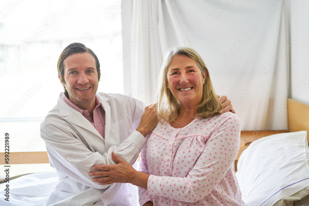 Fototapeta premium Smiling doctor with elderly woman at rehab center