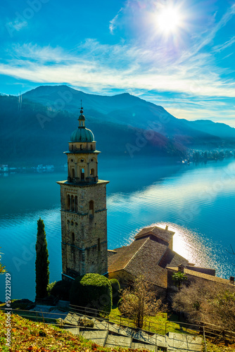 Church Tower Santa Maria del Sasso with Sunlight and Mountain on Lake Lugano in Morcote, Ticino in Switzerland.