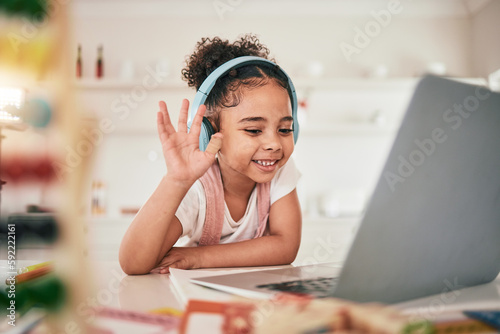 Laptop, video call communication and happy child elearning, wave hello or talking in remote youth development lesson. Home school education, learning in study and young kid listening on online class