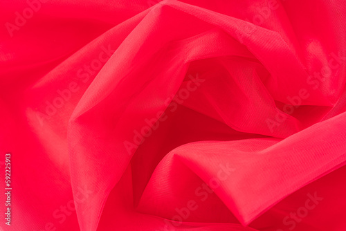 Background of red crumpled tulle close-up.