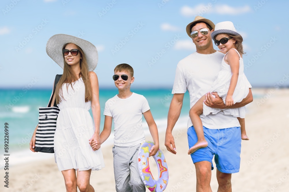 Happy young family having fun in vacation on beach Happy young family having fun in vacation on beach
