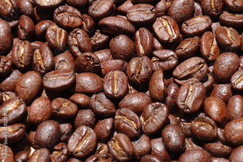 Top view of brown coffee beans, Roasted coffee beans background, Texture freshly roasted coffee beans.