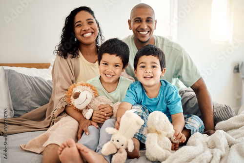 Happy family, bed and portrait of parents and children bonding in a bedroom in a house and playing together. Care, mother and father excited with kids in the morning as love, happiness and care