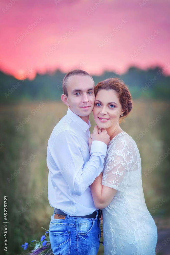 Love story. Wedding day. Newlyweds. Boho style wedding. Bride and groom. Beautiful girl and guy at sunset. Bride with a bouquet of wild flowers. Tenderness. Love. Summer day. Happiness. Portrait of a Love story. Wedding day. Newlyweds. Boho style wedding. Bride and groom. Beautiful girl and guy at sunset. Bride with a bouquet of wild flowers. Tenderness. Love. Summer day. Happiness. Portrait of a