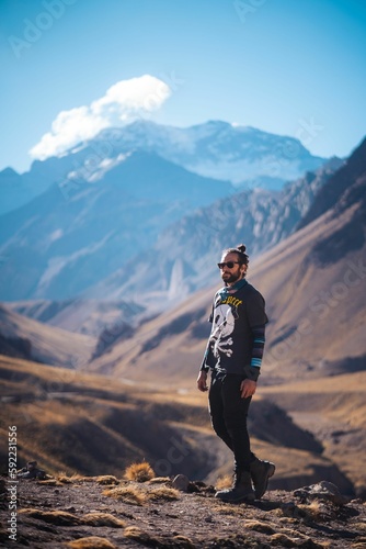 Vertical shot of a male posing while hiking in Aconcagua, Andes, Argentina photo
