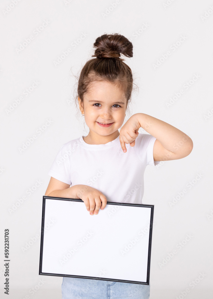 portrait of baby girl holding white drawing Board on white background, young girl is holding a drawing board in her hands. white isolated background portrait of baby girl holding white drawing Board on white background, young girl is holding a drawing board in her hands. white isolated background