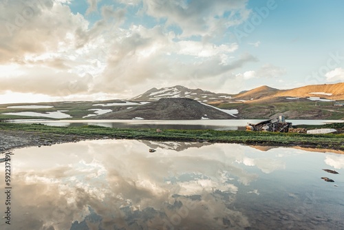Scenic view of Stone Lake with the mount Aragats in Armenia in cloudy sky background