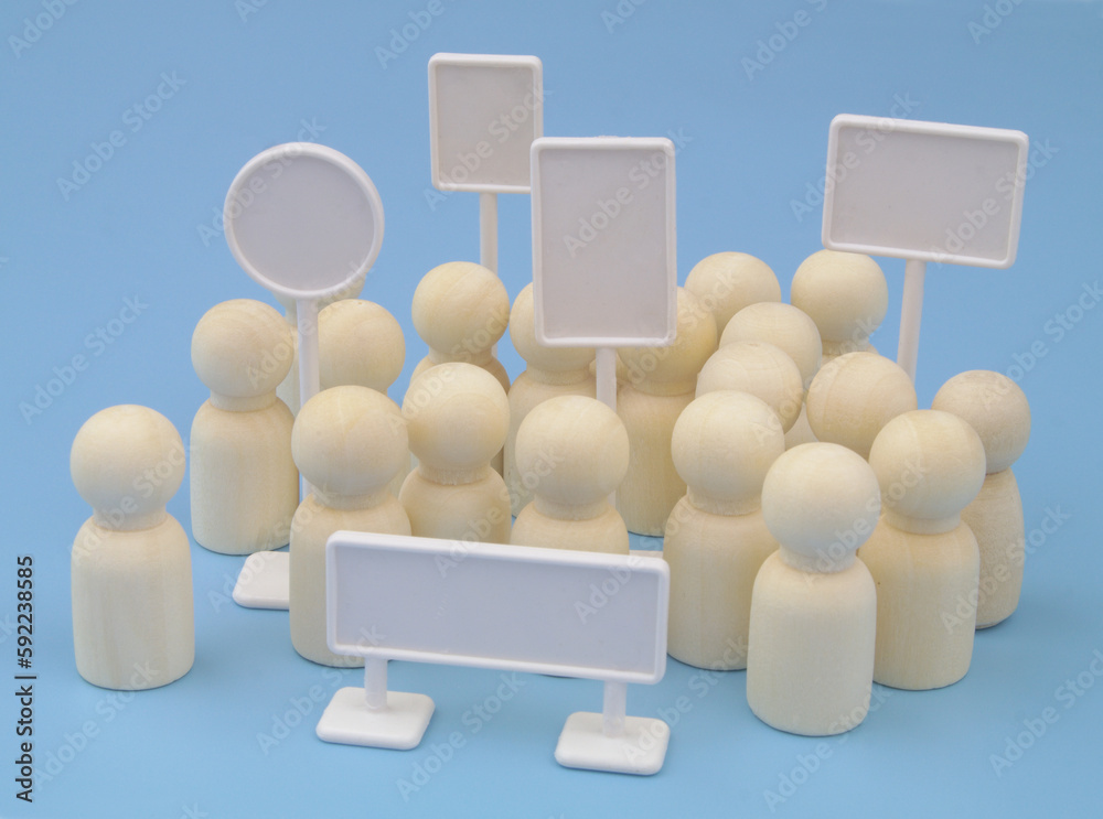 Meeting, demonstration and protest concept. Wooden people figures and white blank banners on blue background. Meeting, demonstration and protest concept. Wooden people figures and white blank banners on blue background.