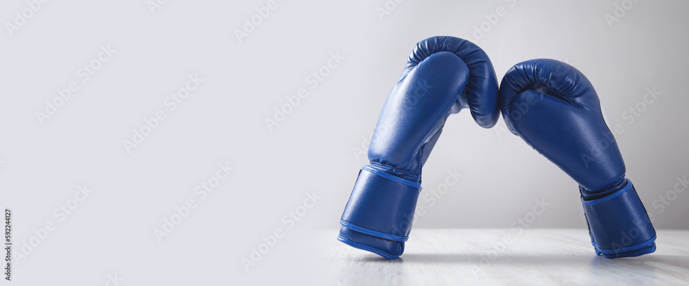 Boxing gloves on white modern desk.