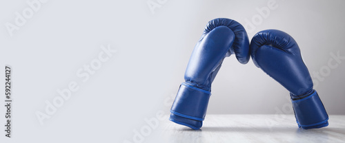 Boxing gloves on white modern desk.
