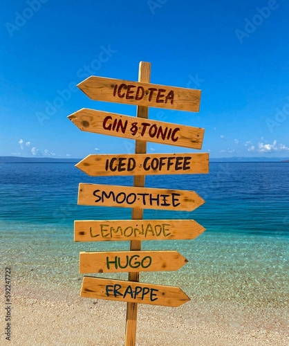 View of direction signs of exotic summer drinks on the beach