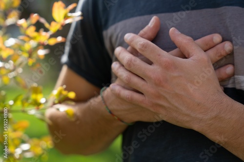 Man's hands on his chest near to heart ,closeup shot