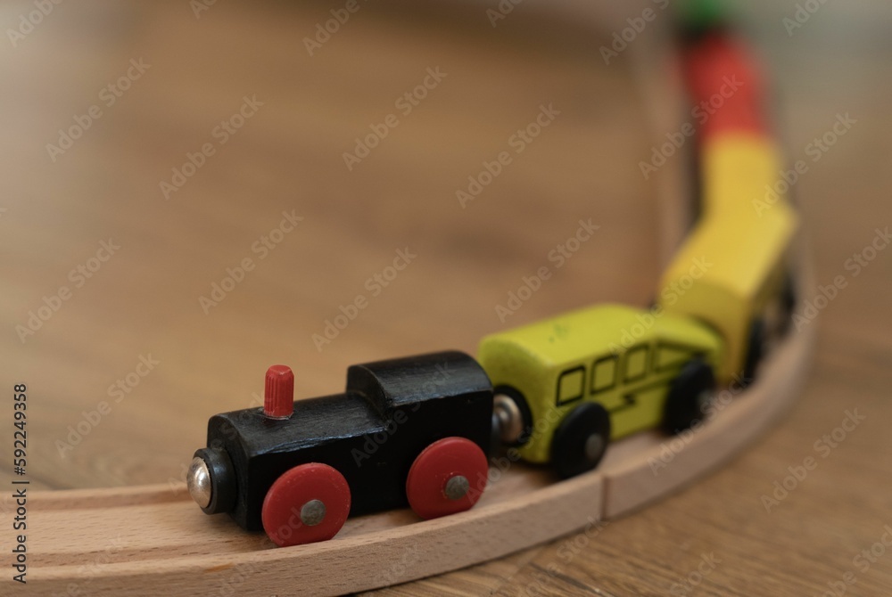 Wooden colorful toy train railway construction on the floor