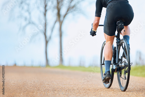 Fototapeta Naklejka Na Ścianę i Meble -  Bicycle, outdoor and person on a bike ride with mockup for sports race on a gravel road. Fitness, exercise and fast athlete doing sport training in nature on a park trail for cardio and workout