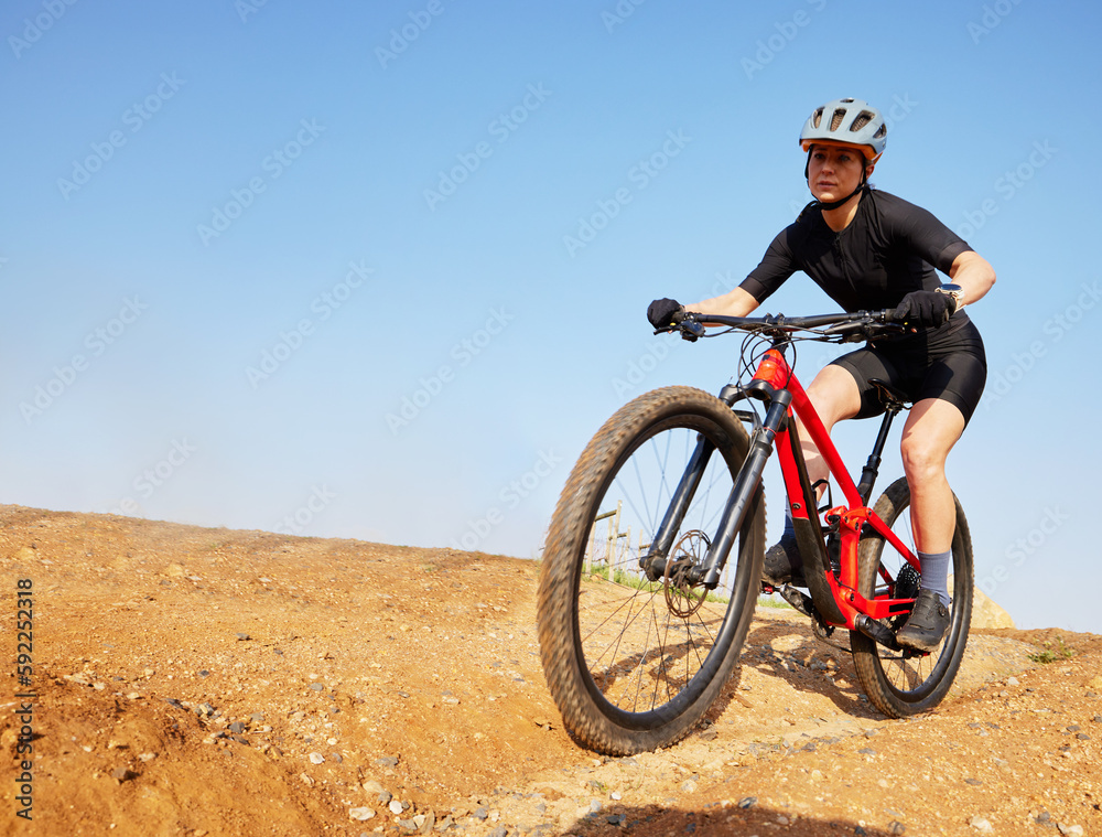 Bicycle, ride outdoor and woman on a bike with cycling for sports race on a gravel road. Fitness, exercise and athlete doing sport training in nature on trail for cardio and workout with mockup Bicycle, ride outdoor and woman on a bike with cycling for sports race on a gravel road. Fitness, exercise and athlete doing sport training in nature on trail for cardio and workout with mockup