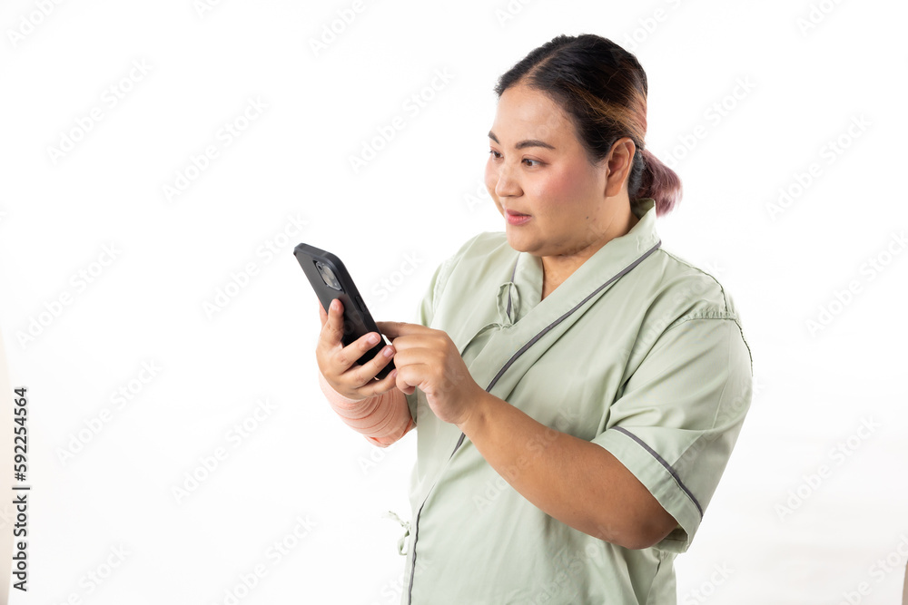 Excite and surprise female patient hand holding mobile phone. Happy winner smiling asian women patient on white background. Fat and overweight obese woman Excite and surprise female patient hand holding mobile phone. Happy winner smiling asian women patient on white background. Fat and overweight obese woman