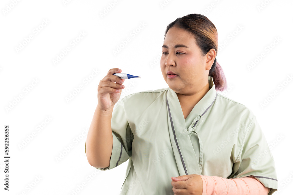 Sick female having fever and headache, flu and check thermometer measure body temperature. Asian women patient on white background. Fat and overweight obese woman Sick female having fever and headache, flu and check thermometer measure body temperature. Asian women patient on white background. Fat and overweight obese woman