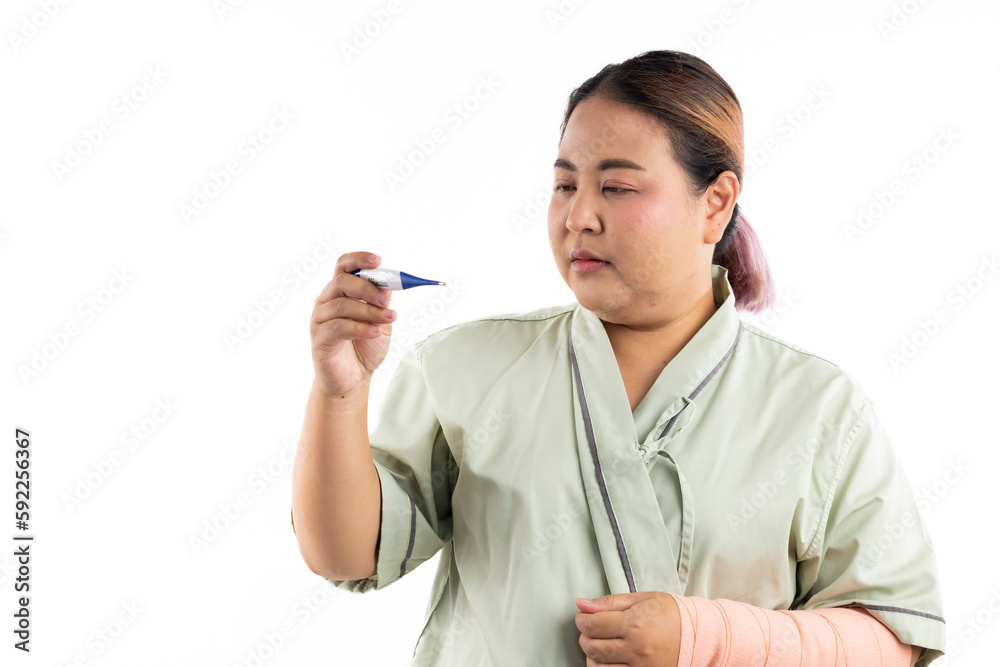 Sick female having fever and headache, flu and check thermometer measure body temperature. Asian women patient on white background. Fat and overweight obese woman Sick female having fever and headache, flu and check thermometer measure body temperature. Asian women patient on white background. Fat and overweight obese woman