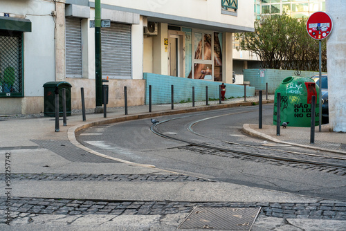 Cobblestone road curve with tramway tracks in lisbon