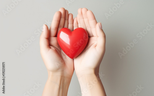 Simple yet powerful image of hands holding a red heart, symbolizing care, love, and the universal sign of life and health.