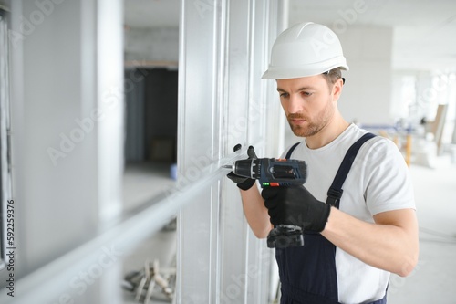 man fasten metal profile frame to the wall for draywall bulkhead