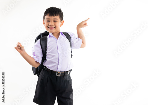 Excited wow fingle point up and side. Thai school uniform with backpack bag. Portrait Young Asian cute boy standing on white background banner. Back to school. photo