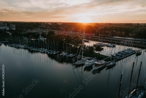 Aerial view of sailing boats moored in the lake in Enkhuizen, Netherlands at sunset