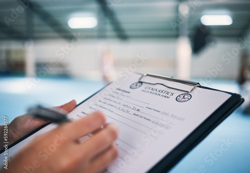 Hand, documents and contract in gym with a coach watching a performance for membership sign up or checklist. Paper, assessment and personal trainer in a sports center for fitness, planning or review