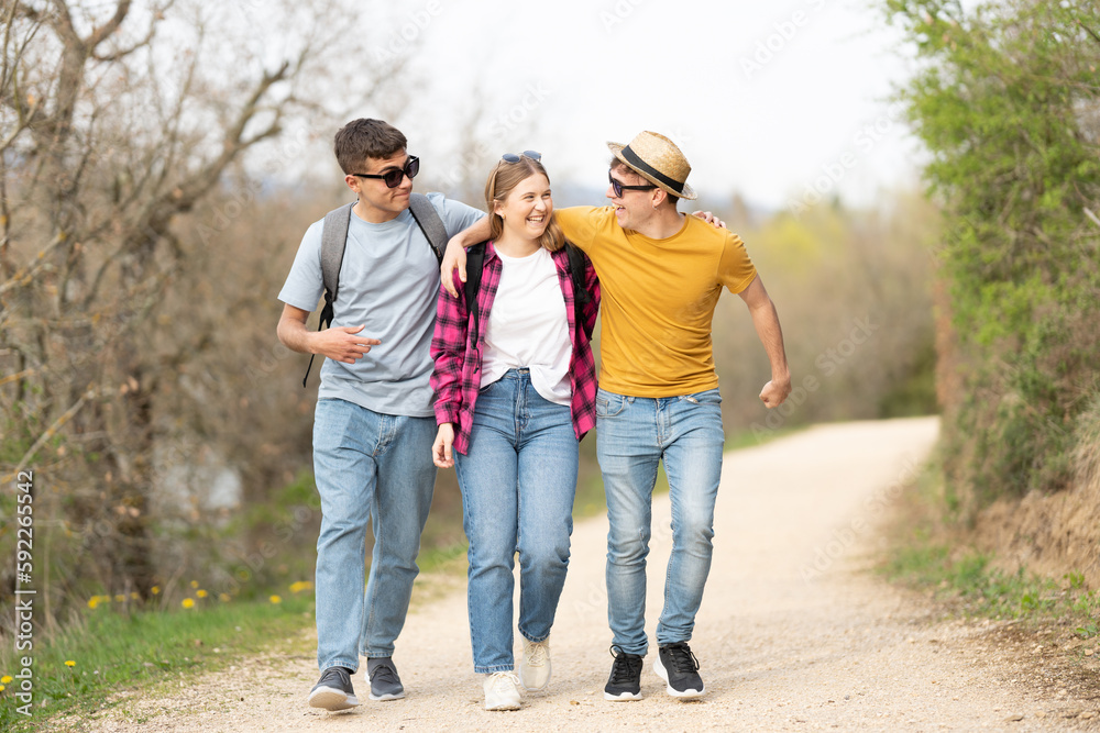 Group of friends walking and embracing