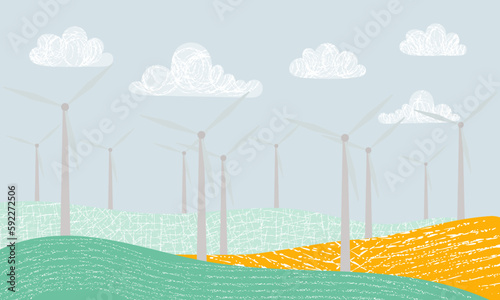 Picture with windmills. Wind energy. Solar energy. A green and yellow wind farm with a blue sky and clouds