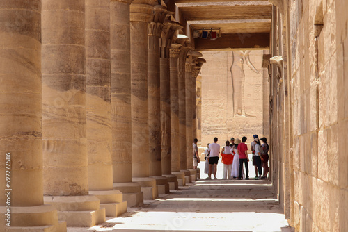 Photography A group of tourists listening to tour guide at Philae temple in Aswan, Egypt