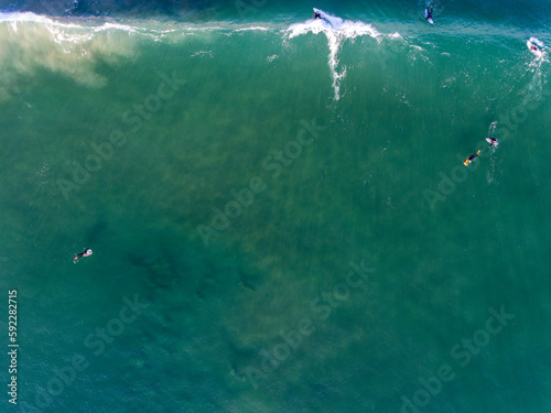 Caparica Beach Aerial Photos of surfist in sea, Portugal