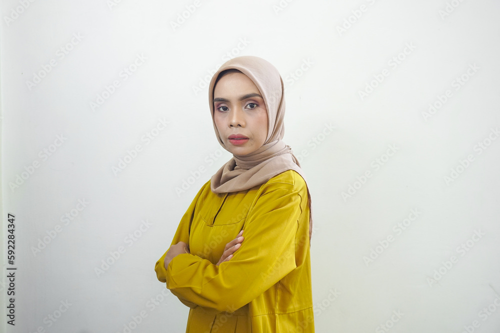 Seriusly young Asian Muslim woman feels confident and joyful isolated over white background Seriusly young Asian Muslim woman feels confident and joyful isolated over white background