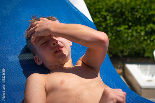 A child has sunstroke. The boy overheated in the sun . Heat stroke