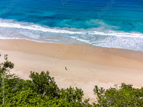 Man walking alone at the beach in Grande Anse photo