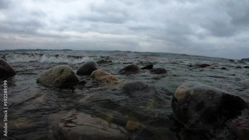 Waves hitting the rocks at the shore Waves hitting the rocks at the shore