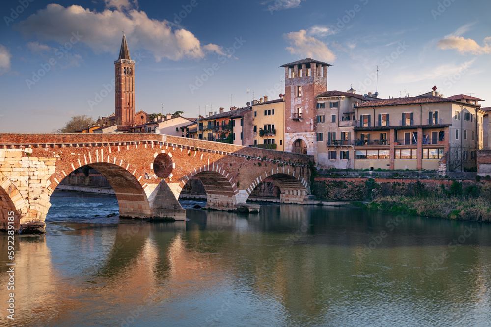 Verona, Italy. Cityscape image of beautiful Italian town Verona with the Stone Bridge over Adige River at sunset.