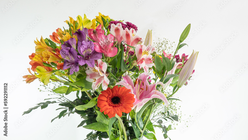 Beautiful multicolored flower bouquet on white background and closeup, with lilies, chrisantemos, pompom, wildflower, etc.