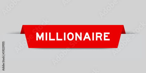 Red color inserted label with word millionaire on gray background