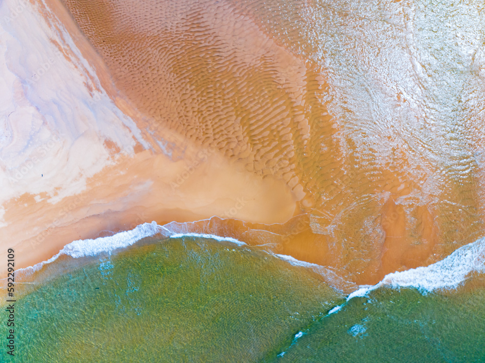 Fototapeta premium Top view Colorful Beach waves sea surface seashore, Amazing waves crashing on sandy shore,Beautiful sand beach,Nature and travel background