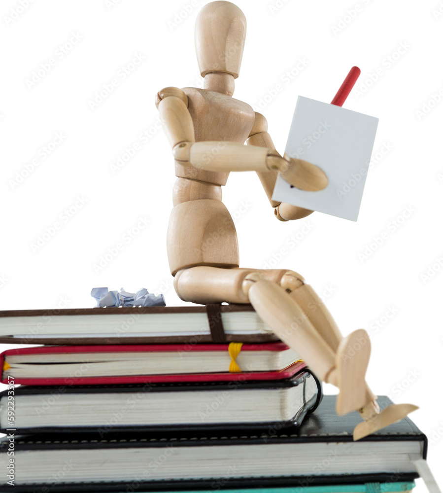 3d image of wooden figurine writing on paper while sitting on books 3d image of wooden figurine writing on paper while sitting on books