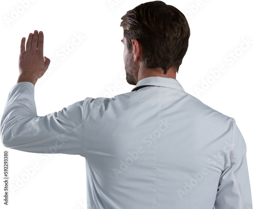 Male doctor using invisible screen against white background