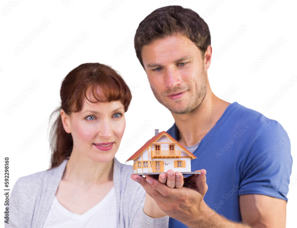 Couple holding a model house Couple holding a model house