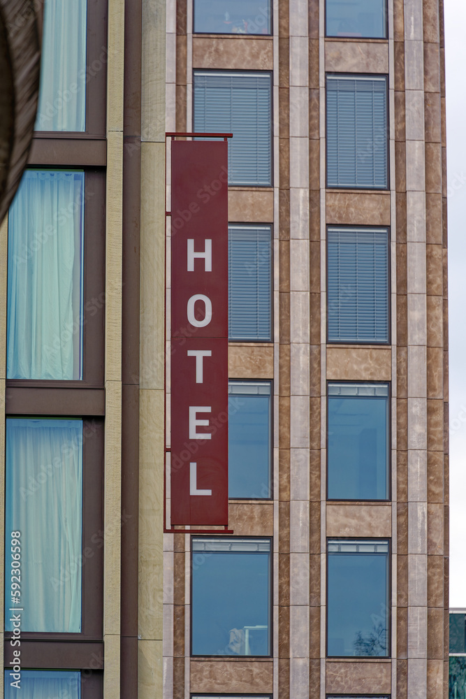 Facade of hotel with brown sign at Swiss City of Wallisellen on a cloudy winter day. Photo taken February 17th, 2023, Wallisellen, Switzerland.
