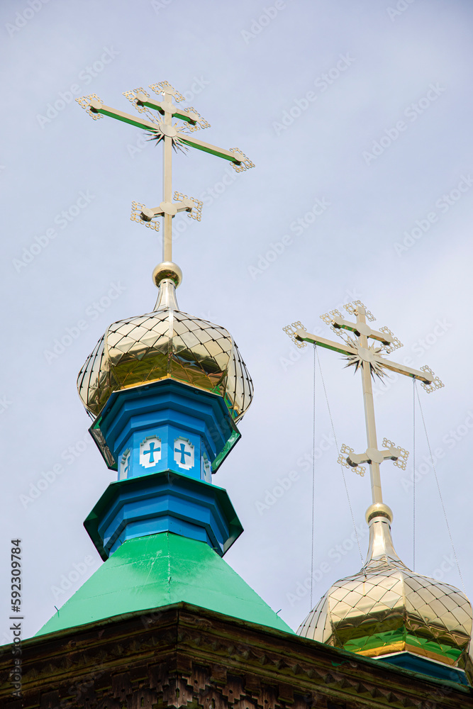 Steeples with gold crosses on Russian Orthodox church in Karakol, Kyrgyzstan. Steeples with gold crosses on Russian Orthodox church in Karakol, Kyrgyzstan.