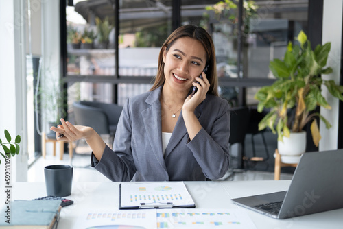 Young professional businesswoman having a phone call with her bos about company project.