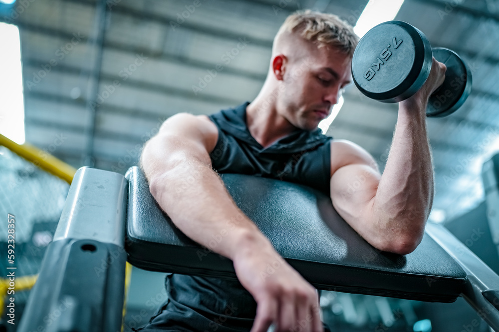 Male athlete exercising in the gym, lifting weights, pulling joints. Male athlete exercising in the gym, lifting weights, pulling joints.
